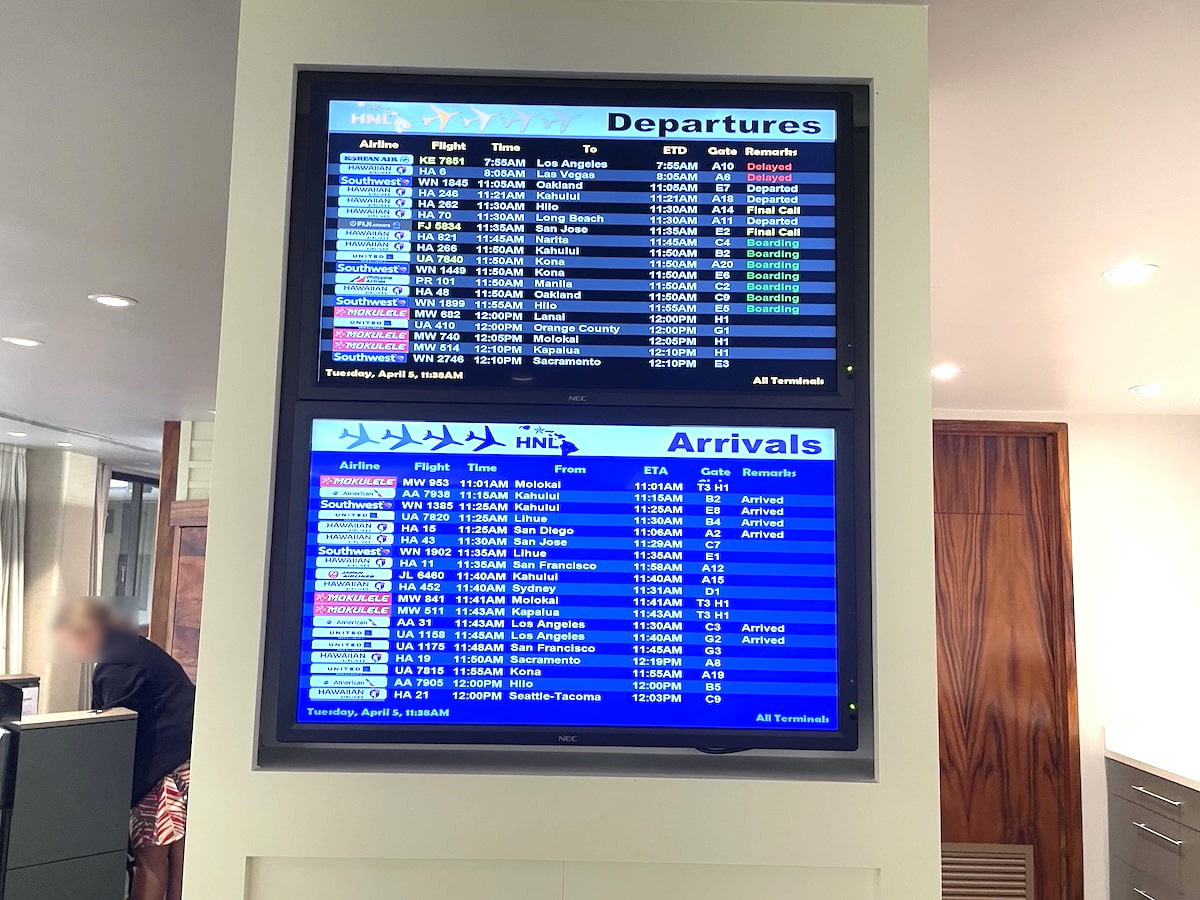 ホノルル空港にあるコオリナ・クラブ・ラウンジのスクリーンでフライト情報を確認